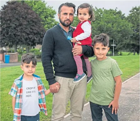  ?? Picture Andrew Cawley ?? Omid Asak, with his children, Jebran, left, Ahmad Shah, and toddler Maryiam near their home in Irvine on Thursday