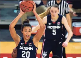  ?? Kathy Willens / Associated Press ?? UConn’s Olivia Nelson-Ododa (20) looks to pass as Paige Bueckers (5) looks on during a win at St. John’s last week.