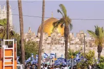  ?? ARIEL SCHALIT/ASSOCIATED PRESS ?? Israelis wave national flags in front of Damascus Gate outside Jerusalem’s Old City to mark Jerusalem Day, an Israeli holiday celebratin­g the capture of the Old City during the 1967 Mideast war.