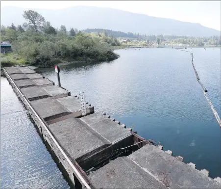  ??  ?? Cowichan Lake, on the left side of the weir, flows through locks into the Cowichan River. Homeowners rights on the lake have occasional­ly been in conflict with the needs of the fish and aquatic life that depend on water flows in the river.