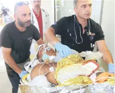  ??  ?? Medics transfer an man injured during an earthquake off the island of Kos, to the hospital of the city of Heraklion on the island of Crete, Greece. — Reuters photo