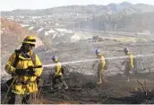  ?? BILL WECHTER ?? Firefighte­rs douse flames from a brush fire on the Palomar College campus in San Marcos on Thursday.