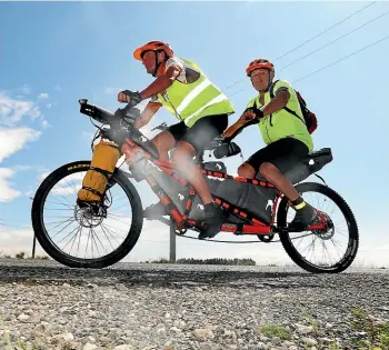  ?? KAVINDA HERATH/STUFF ?? Timaruvian­s Russell Shanks, left, and Paul Glass, who is blind, during their tandem bike ride from Cape Reinga to Bluff.