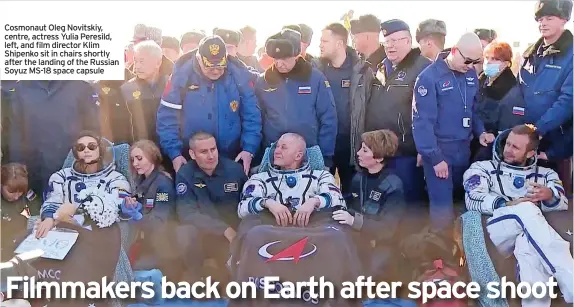  ?? ?? Cosmonaut Oleg Novitskiy, centre, actress Yulia Peresild, left, and film director Klim Shipenko sit in chairs shortly after the landing of the Russian Soyuz MS-18 space capsule