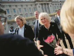  ?? CHRISTOPHE ENA/AP ?? Camilla, the wife of King Charles III now known as the queen consort, greets people mourning Queen Elizabeth II on Friday outside Buckingham Palace in London.