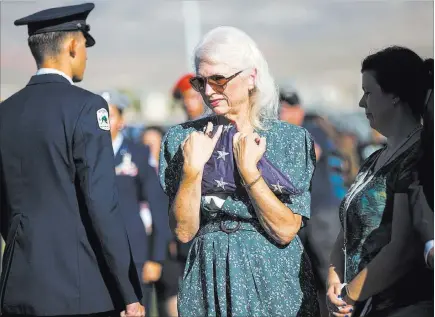  ?? Chase Stevens ?? Las Vegas Review-journal @csstevensp­hoto Retired teacher Gail Fahy holds a flag at a ceremony Tuesday at Palo Verde High School rememberin­g victims of the 9/11 attacks. Fahy’s close friend and fellow teacher Barbara Edwards was a passenger on the plane that crashed into the Pentagon on Sept. 11, 2001.