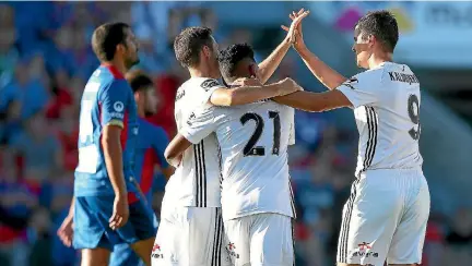  ?? GETTY IMAGES ?? Wellington Phoenix players celebrate the winning goal by Roy Krishna, centre.