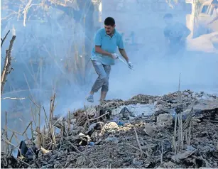  ?? Picture: AFP/ZEIN AL RIFAI ?? CRUCIAL TALKS: Syrians use dirt to put out a fire at the scene of a reported air strike in the district of Jisr al-Shughur, in the Idlib province, on Tuesday.