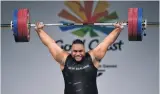  ??  ?? David Liti (21), of Auckland, wears a winner’s smile as he lifts for gold in the 105+kg weightlift­ing final. His combined total of 403kg was a Commonweal­th Games record.