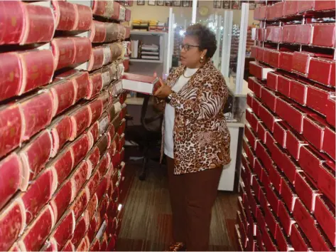  ?? (Pine Bluff Commercial/Eplunus Colvin) ?? Jefferson County Circuit Clerk Barbara Collins organizes old deed books in the storage area that she said has run out of room for future books.