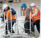  ?? Photo / ODT ?? Fishermen from the first group to arrive in New Zealand prepare to depart from Dunedin.