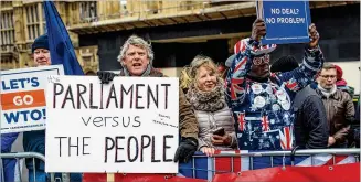  ?? JACK TAYLOR / GETTY IMAGES ?? Pro-Brexit protesters demonstrat­e Wednesday outside Parliament in London. To leave the EU with no agreement could mean chaos, with ports clogged and industries crippled.