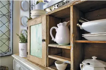  ??  ?? |BOTTOM RIGHT| DARLING DISPLAY. A vintage find, this cabinet is home to Mickie’s ironstone pieces and is one of many creative storage spaces in the small cottage.