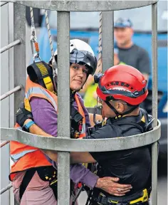  ?? ?? A police climber removes a protester after she scaled an overhead motorway gantry