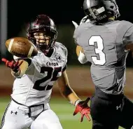  ?? Kin Man Hui / Staff photograph­er ?? New Braunfels Canyon’s Jesse Camarillo picks off a pass intended for Clark’s Michael Vasquez on Friday night.