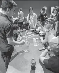  ??  ?? David Hill, seated, center at right, leads a group in the game Two Rooms and a Boom during last year’s Spa-Con in Hot Springs.