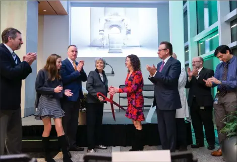  ?? SUSAN L ANGSTADT—MEDIANEWS GROUP ?? Reading Hospital hosted a ribbon cutting at the McGlinn Cancer Institute to showcase the new MRIdian MRI-Guided Linear Accelerato­r. In the center cutting the ribbon are Bobbie McGlinn, holding scissors, and her daughter, Chrissy McGlinn Auman.