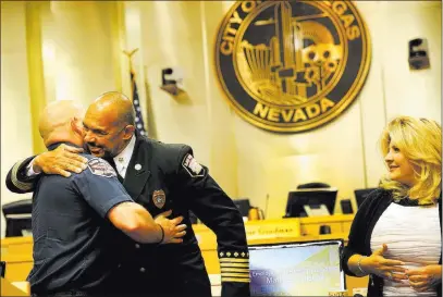  ?? Erik Verduzco ?? Las Vegas Review-journal @Erik_verduzco Las Vegas Fire and Rescue Chief William Mcdonald, right, embraces paramedic Matthew Driscoll, who was recognized as the employee of the month Wednesday during a City Council meeting at Las Vegas City Hall....