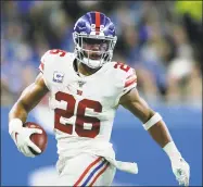  ?? Duane Burleson / Associated Press ?? New York Giants running back Saquon Barkley carries the ball against the Detroit Lions.