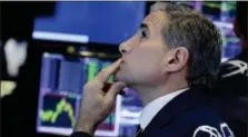  ?? RICHARD DREW — THE ASSOCIATED PRESS ?? Specialist Anthony Rinaldi works at his post on the floor of the New York Stock Exchange, Tuesday.