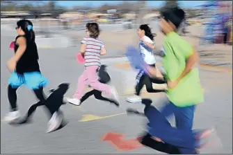  ??  ?? ABOVE: Blurring as they pass the camera, members of Sierra Vista Elementary School’s runners club are shown in action. The number of miles some students run is impressive. Third-grader Jeremiah Sanchez, was the top runner last year with 210 miles. “My...