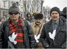  ?? AP ?? Men wearing white dove emblems take part in a Movement for the People protest in Moldova’s capital Chisinau.