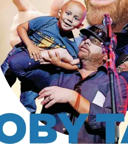  ?? [PHOTO BY
NATE BILLINGS, THE
OKLAHOMAN] ?? Toby Keith lifts up cancer patient Axel Epps, 4, during a fundraiser for the OK Kids Korral on June 2 at Riverwind Casino in Norman.