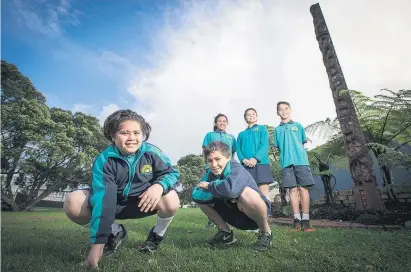  ?? Picture / Greg Bowker ?? Students Manu Repia, Kisharn Dunn, Brooklyne Friend, Tai Churchill and Ricco Graham from Flanshaw Rd School, Te Atatu South, with their carved pou.