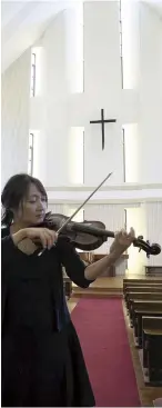  ?? The Yomiuri Shimbun ?? Tomoko Kurita plays a violin that survived the atomic bombing of Hiroshima on Sunday in the city.