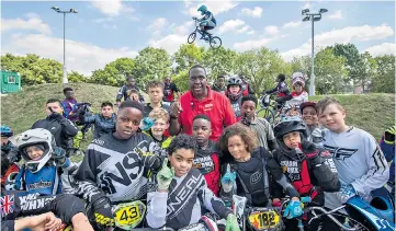  ??  ?? Ride of their life: Coach CK with young cyclists at Burgess Park BMX track