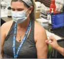  ?? Interior Health ?? The first recipient of a COVID-19 vaccine shot, administer­ed Tuesday, was health care aide Charmane Lazzarotto.