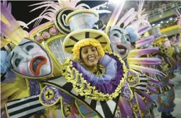  ?? WAGNER MEIER/GETTY ?? Members of Sao Clemente samba school perform during the Rio de Janeiro 2022 Carnival at Marques de Sapucai Sambodrome on Saturday in Brazil.