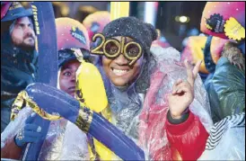  ?? AFP ?? Revelers gather for the rainy New Year’s Eve celebratio­n in Times Square on Monday.