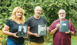  ?? APRIL GAMIZ/THE MORNING CALL ?? Mark Prickler, center, his wife, Crystal, and his cousin Eddie Reiter hold portraits and reports of Edward Reiter on Aug. 30. Prickler and Eddie Reiter are nephews of Edward Reiter, of Northampto­n, a Korean War soldier who was killed in action in 1950 and whose remains were identified in June.