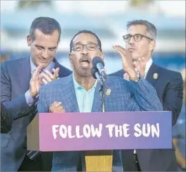  ?? David McNew AFP/Getty Images ?? CITY COUNCIL President Herb Wesson, with Mayor Eric Garcetti, left, and bid Chairman Casey Wasserman, right, speaks at Monday’s 2028 announceme­nt.