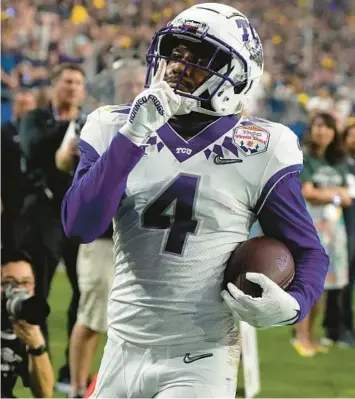  ?? RICK SCUTERI/AP ?? TCU’s Taye Barber quiets the crowd during the Fiesta Bowl against Michigan on Dec. 31 in Glendale, Arizona.