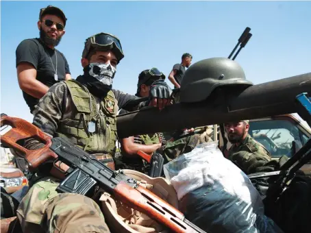  ?? AFP ?? Members of the eastern Libyan National Army (LNA) special forces, led by Gen. Khalifa Haftar, gather in the city of Benghazi on their way to the frontline.