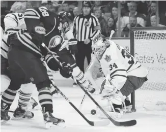  ?? GARY WIEPERT/THE ASSOCIATED PRESS ?? The Sabres’ Zemgus Girensons, of Latvia, chases a rebound in front of Toronto Maple Leafs’ James Reimer during the first period of Friday’s game in Buffalo, N.Y.