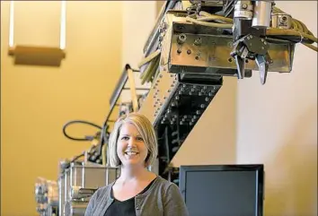  ?? Pam Panchak/Post-Gazette ?? Rebecca Hartley, director of operations for the Clemson University Center for Workforce Developmen­t and chief workforce officer for the Advanced Robotics in Manufactur­ing Institute, stands in front of the “Workhorse,” one of the first robots built by...