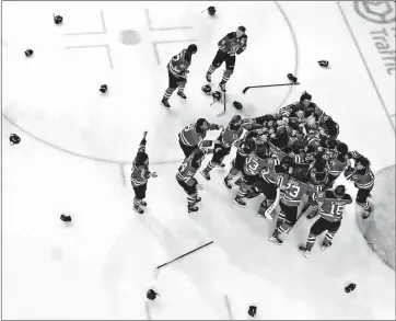  ?? CANADIAN PRESS PHOTO ?? Equipment is scattered on the ice as Quebec Remparts players celebrate after Quebec defeated the Seattle Thunderbir­ds during Memorial Cup final hockey action, in Kamloops, B.C., on Sunday.