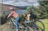  ?? ?? Brother and sister, Ruairidh and Grace MacMaster on their bikes for their fundraisin­g triathlon.