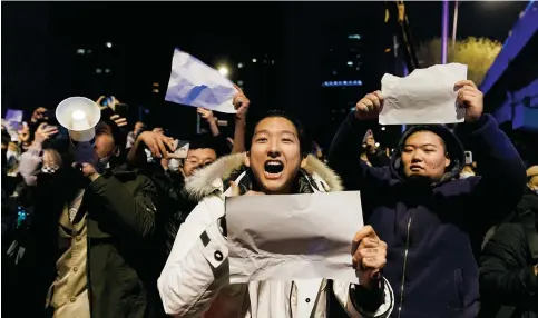  ?? Photo: Reuters ?? People hold blank sheets of paper during a protest last week in Beijing over the country’s anti-pandemic measures such as lockdowns and endless mass testing.