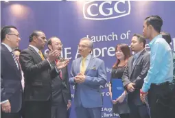  ??  ?? Agil (centre), Deputy Minster of Youth And Sport Datuk M. Saravanan (second from left) and Zamree (left) sharing a light moment with participan­ts during the launch of the CGC Apprentice Scheme 2017 yesterday.