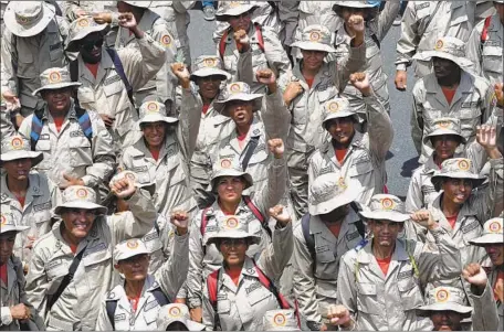  ?? Yuri Cortez AFP/Getty Images ?? MEMBERS of the Bolivarian Militia join a government rally in Caracas. The group, with up to 1 million members, is loyal to the president.