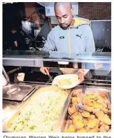  ??  ?? Olympian Warren Weir helps himself to the delicious spread prepared by chef Karl Thomas.