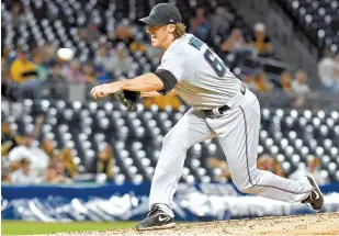  ?? AP-Yonhap ?? Miami Marlins pitcher Brian Moran throws his first pitch in his major league debut in the fourth inning against the Pittsburgh Pirates in Pittsburgh, Thursday.