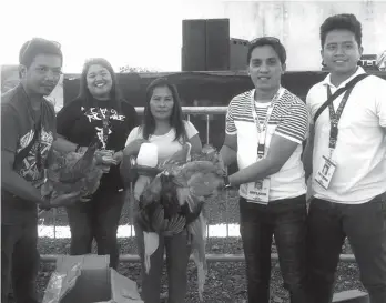  ??  ?? STARTER KITS. Beneficiar­ies of Laak, Compostela Valley receive starter kits following a training on Enhanced Native Chicken Production Raising and Motorcycle/Small Engine Servicing