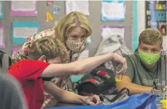  ?? ALYSSA POINTER/ATLANTA JOURNAL-CONSTITUTI­ON VIA AP ?? U.S. Secretary of Education Betsy DeVos interacts with Forsyth Central High School Honors Chemistry students while at the school Tuesday in Cumming, Georgia.