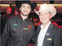  ??  ?? Pictured at the SRO tournament are Flames right winger Michael Frolic, left, with tournament volunteer committee member David Zaleschuk.