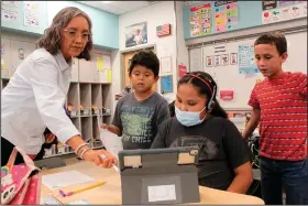  ?? ?? Teacher Arleen Franklin explains a math lesson to her students Sept. 21 at Judy Nelson Elementary School in Kirtland, N.M.